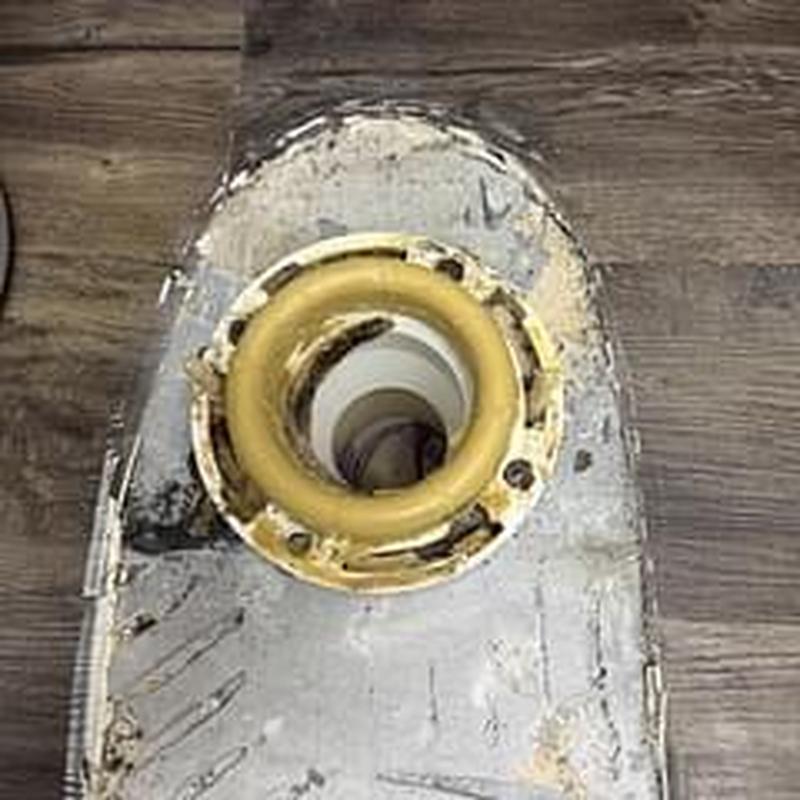 Toilet flange with old wax ring on wood floor Toilet flange with old wax ring on wood floor