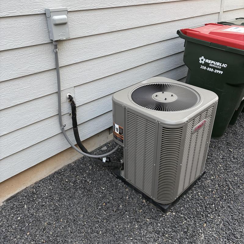 Outdoor Lennox air conditioning unit beside house wall