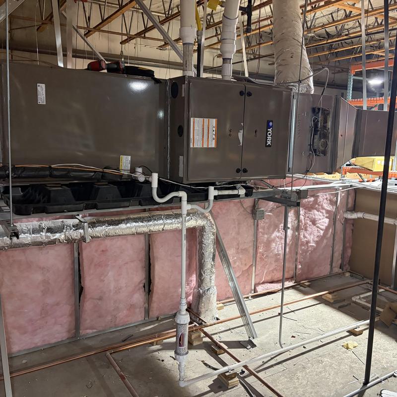 York HVAC unit with exposed ductwork and piping York HVAC unit with exposed ductwork and piping