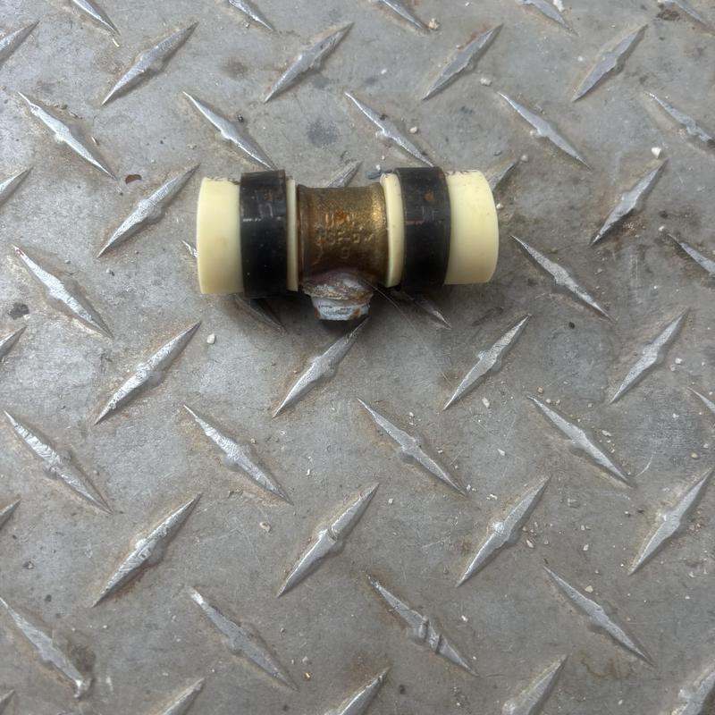 Metal plumbing fitting with corrosion and plastic tubing ends Metal plumbing fitting with corrosion and plastic tubing ends