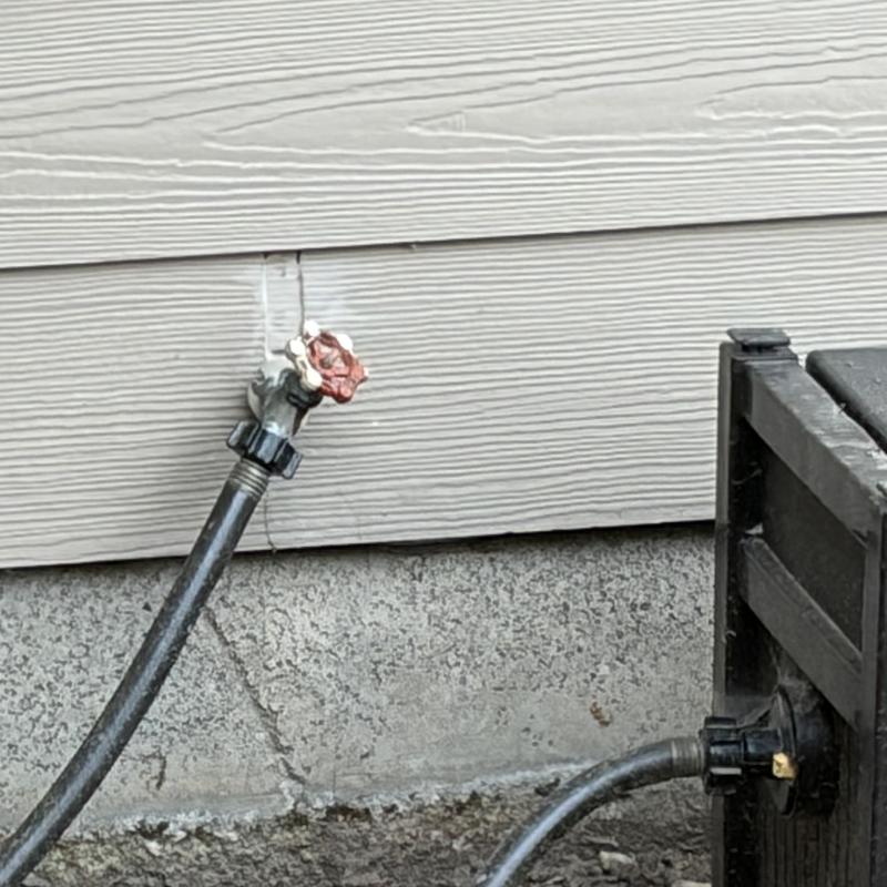 Hose bib leaking with garden hose attached outside home Hose bib leaking with garden hose attached outside home