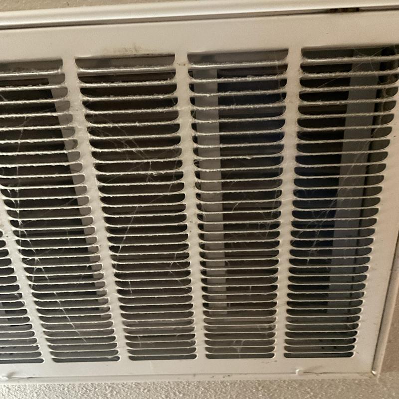 HVAC air vent with dusty filter and debris buildup