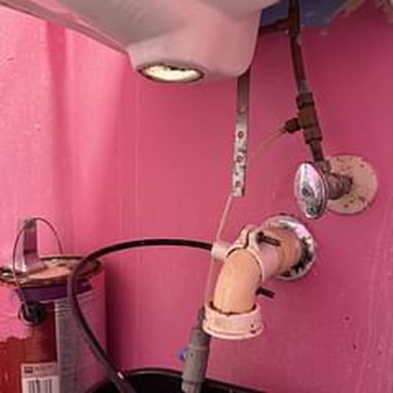 Pop-up assembly and drain pipes under bathroom sink Pop-up assembly and drain pipes under bathroom sink