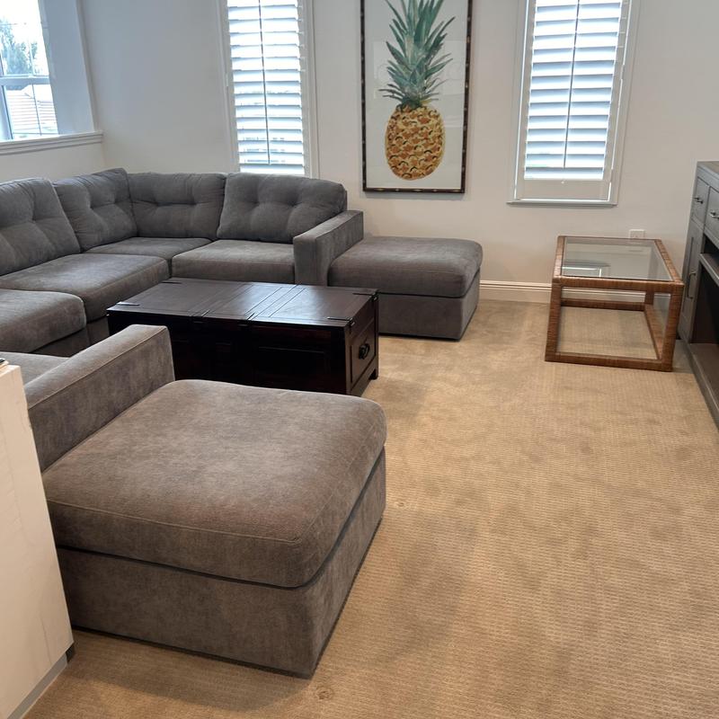 Gray sectional sofa in living room with coffee table