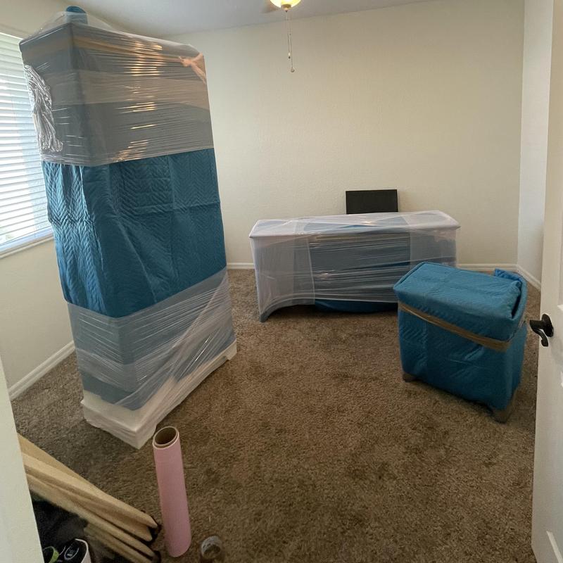 Baby grand piano and furniture wrapped for moving