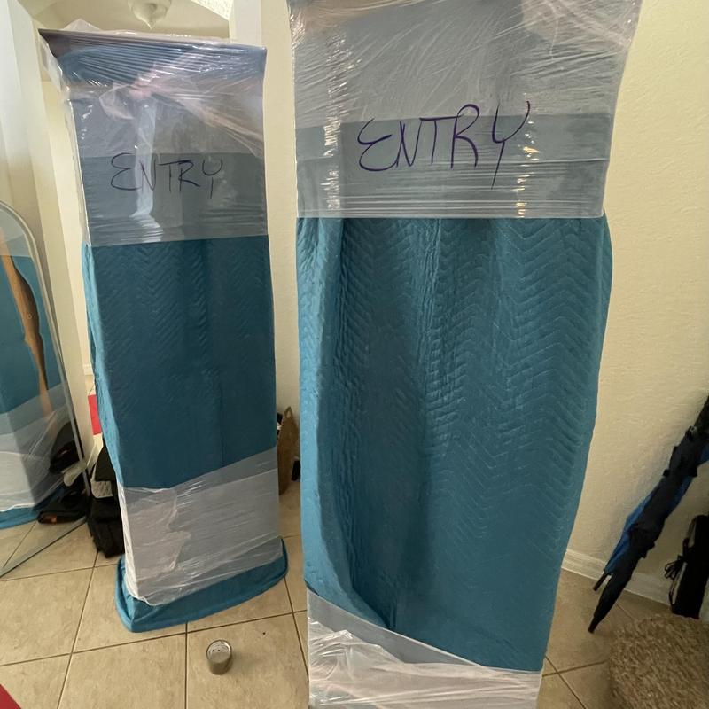 Upright furniture wrapped for moving protection