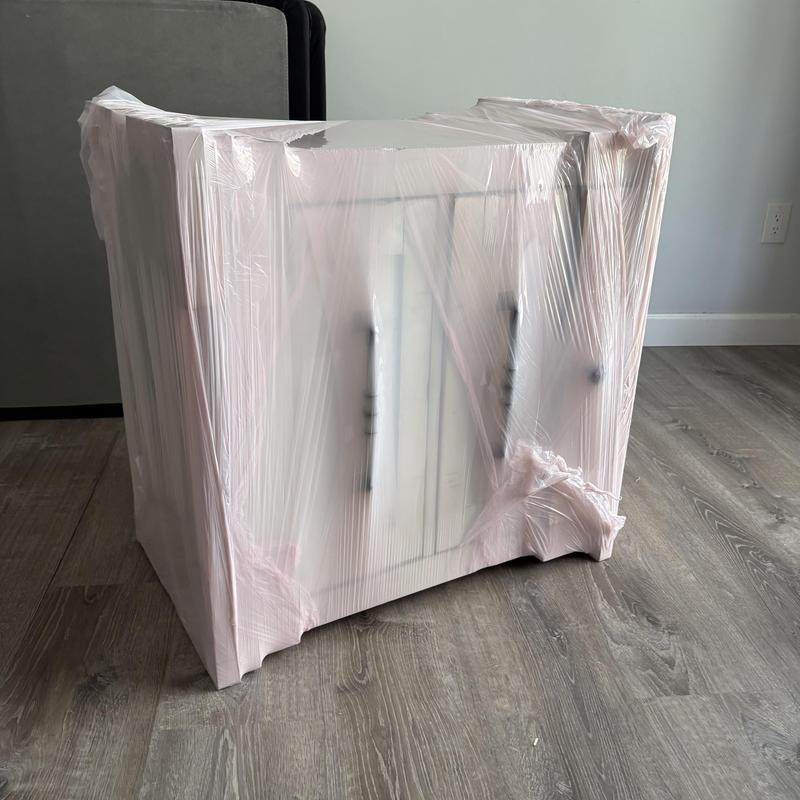 Furniture cabinet wrapped in protective plastic for moving