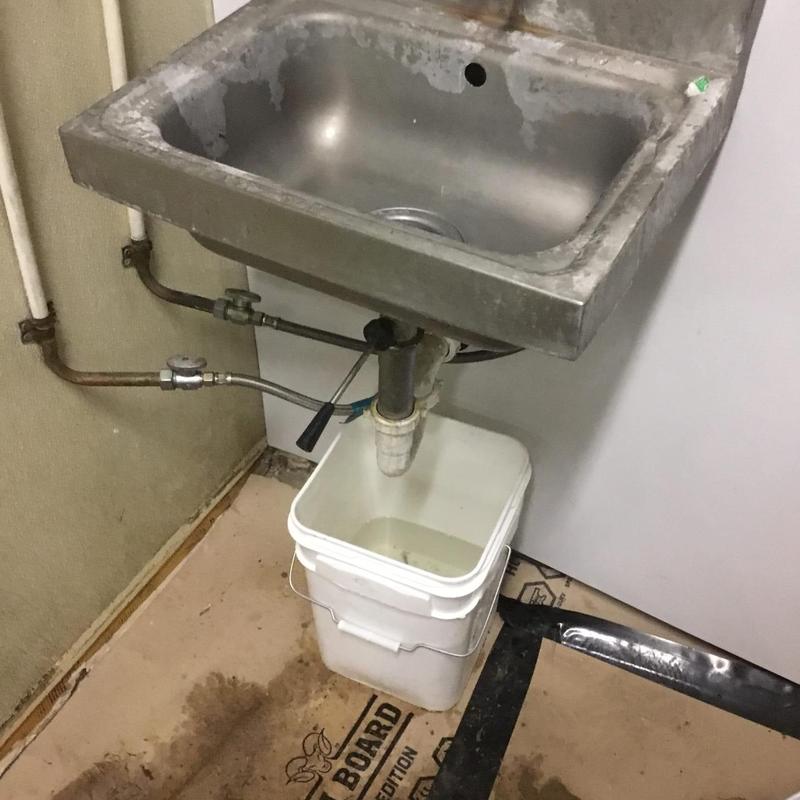 Triple basin sink plumbing with leak and bucket container Triple basin sink plumbing with leak and bucket container