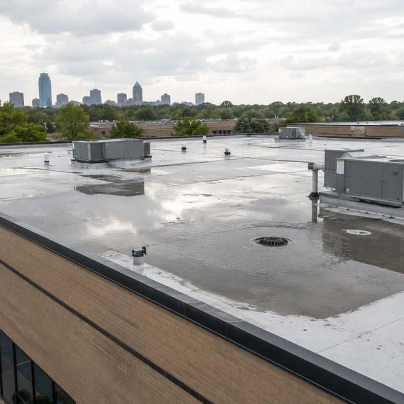 Commercial flat roof with HVAC units and drainage system Commercial flat roof with HVAC units and drainage system
