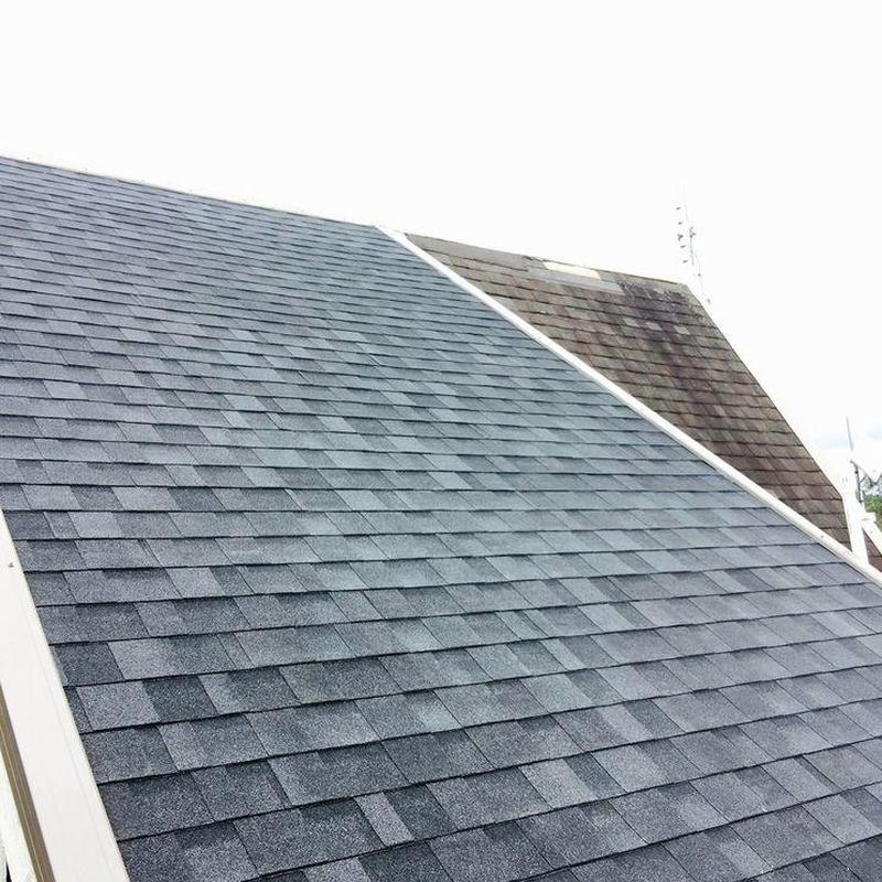 Asphalt shingle roof with new and old sections visible Asphalt shingle roof with new and old sections visible