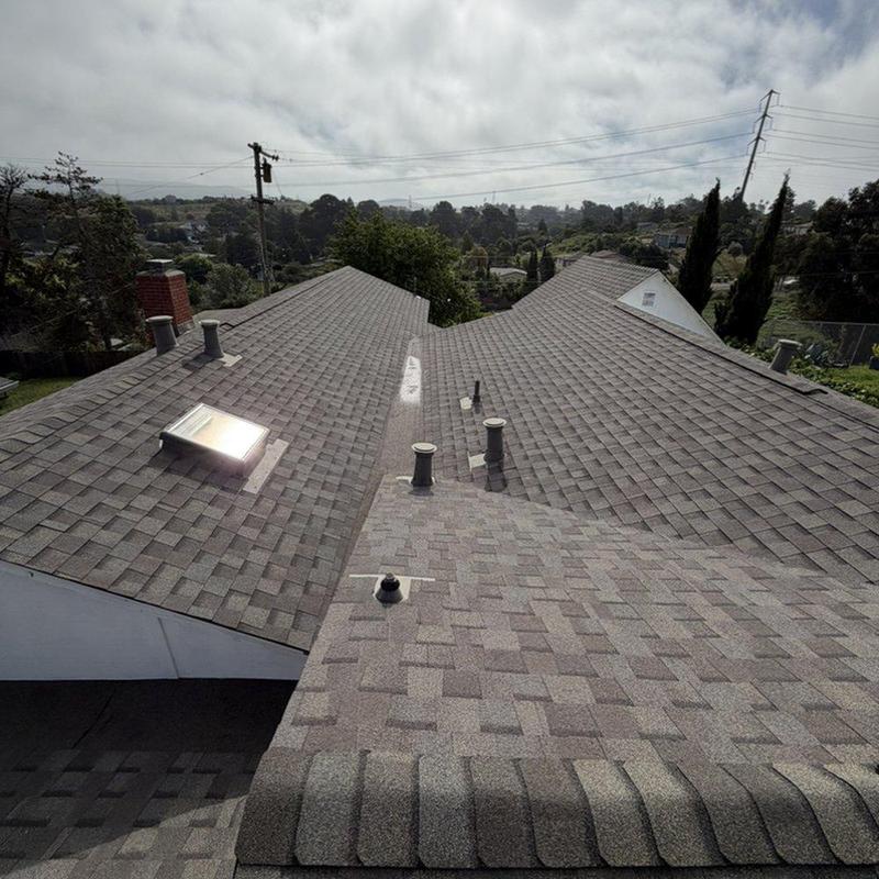 Asphalt shingle roof installation with vent pipes Asphalt shingle roof installation with vent pipes