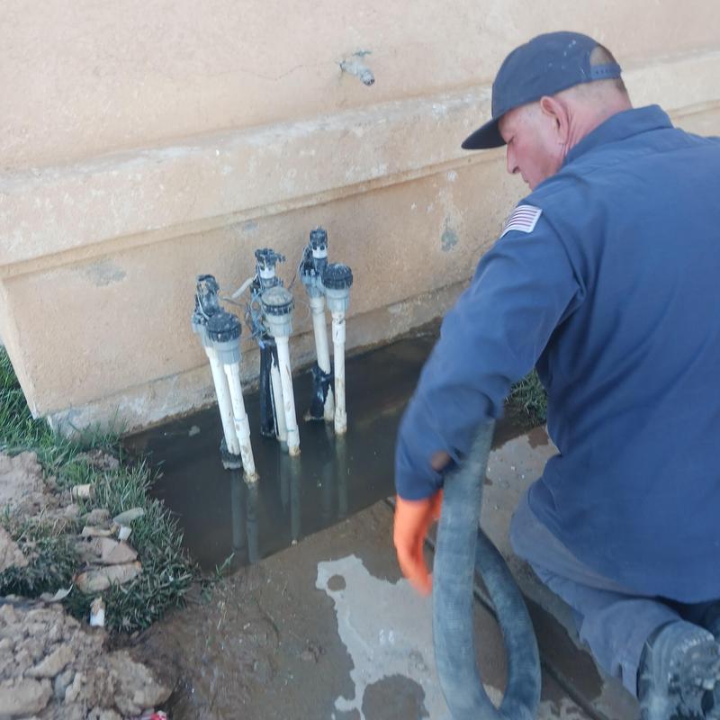 Irrigation system valves flooding near building wall Irrigation system valves flooding near building wall