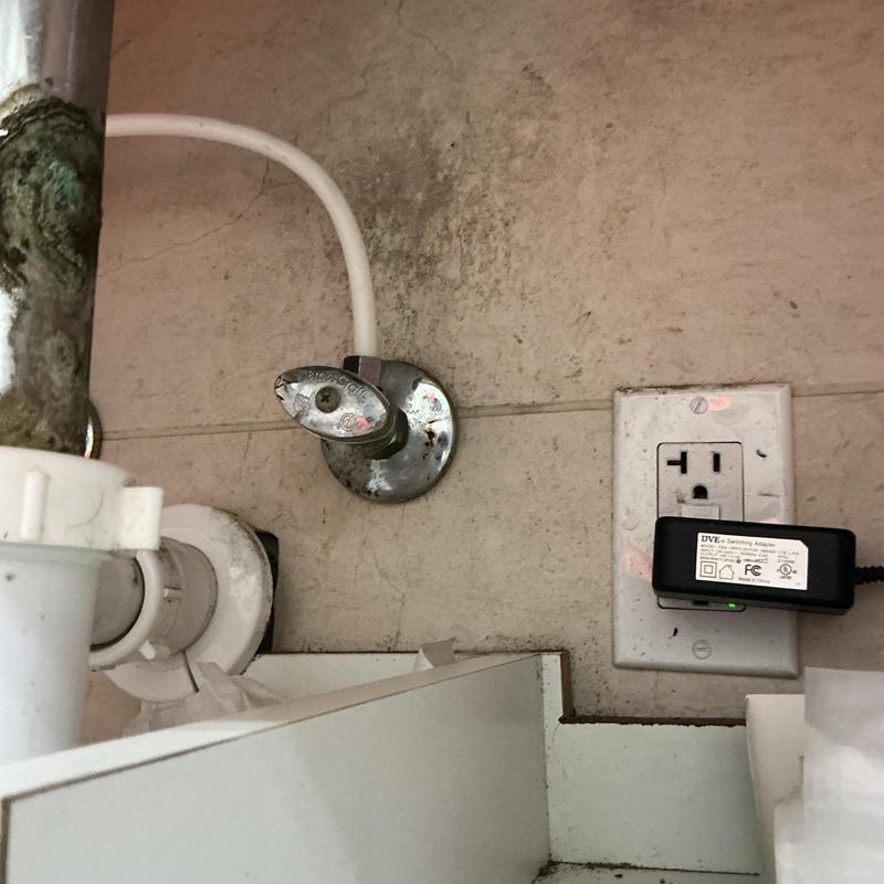 Angle stop valve leak tightening under sink in bathroom Angle stop valve leak tightening under sink in bathroom