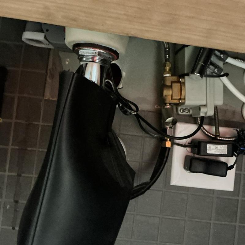 Soap dispenser plumbing with electrical connections under sink Soap dispenser plumbing with electrical connections under sink