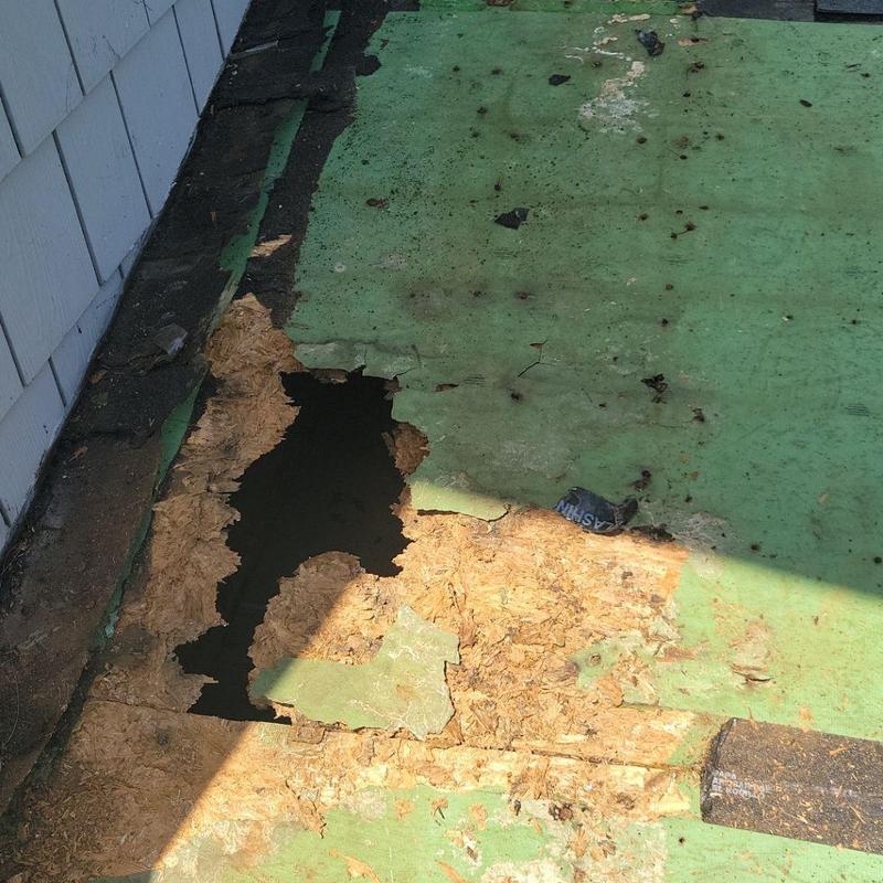 Roof decking with water damage and holes exposed Roof decking with water damage and holes exposed