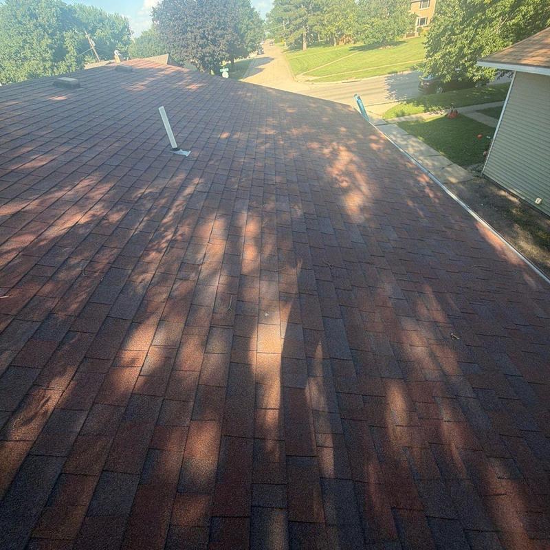 Asphalt shingle roof with vent pipe and gutter near street Asphalt shingle roof with vent pipe and gutter near street