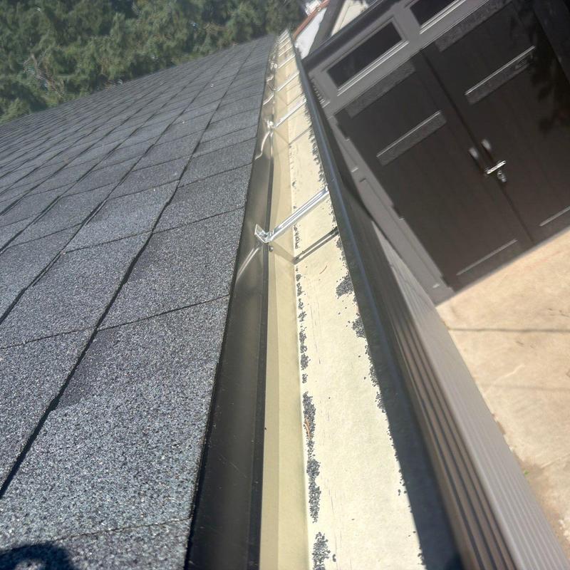 Roof gutter with hangers and asphalt shingles Roof gutter with hangers and asphalt shingles