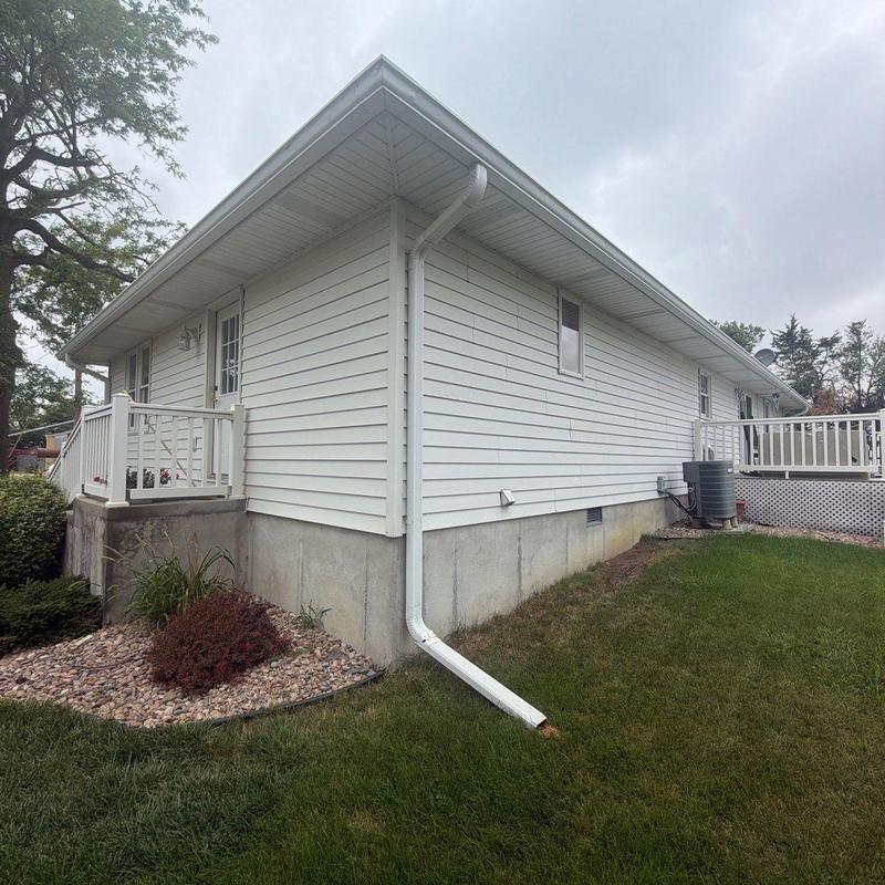 Vinyl siding and gutter downspout on house exterior Vinyl siding and gutter downspout on house exterior