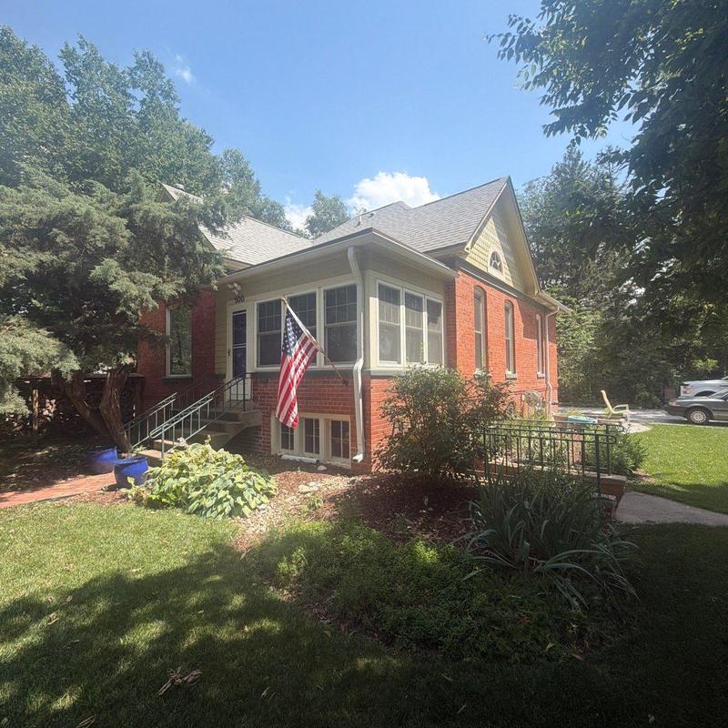 Asphalt shingle roof on brick house with landscaping Asphalt shingle roof on brick house with landscaping