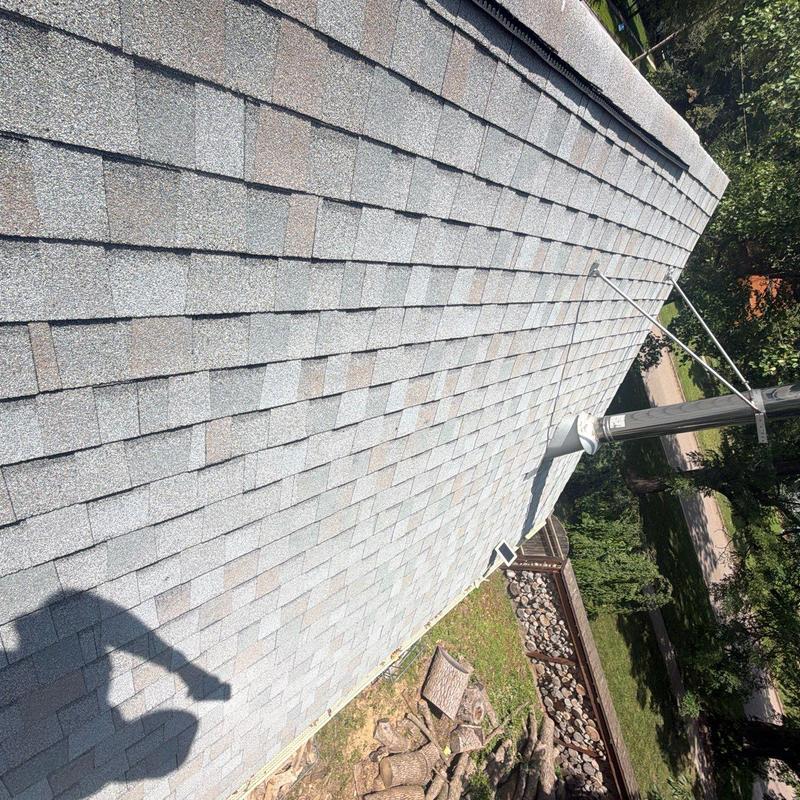 Asphalt shingle roof with metal vent pipe and wires Asphalt shingle roof with metal vent pipe and wires