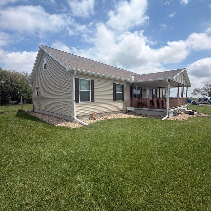 Asphalt shingle roof on residential house with porch Asphalt shingle roof on residential house with porch