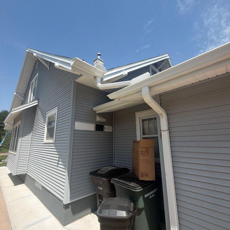 Vinyl siding and gutter system on residential house Vinyl siding and gutter system on residential house