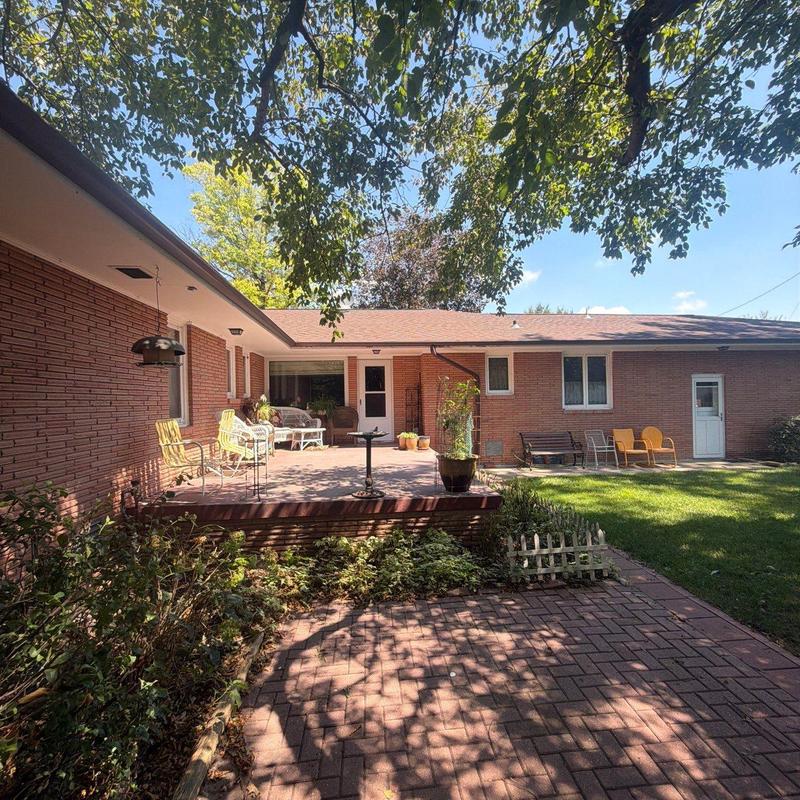 Roof shingles on brick house with backyard patio Roof shingles on brick house with backyard patio