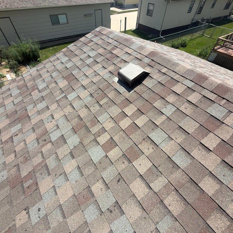 Asphalt shingle roof with vent and visible wear Asphalt shingle roof with vent and visible wear