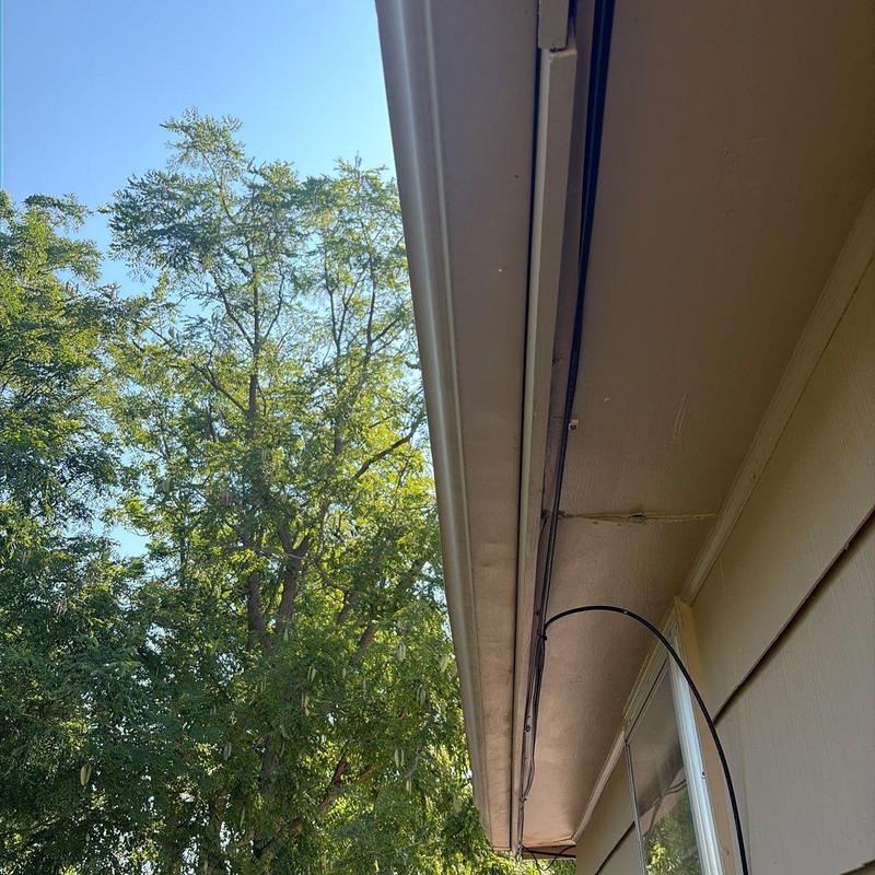 Gutter system along house roofline with wiring Gutter system along house roofline with wiring