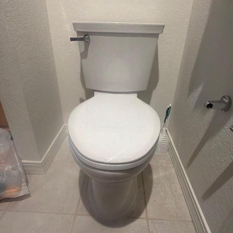 Toilet installation in bathroom corner with toilet brush Toilet installation in bathroom corner with toilet brush