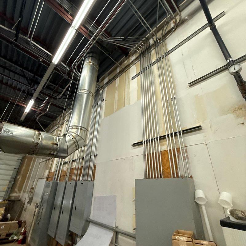Electrical conduit installation and metal ductwork in warehouse