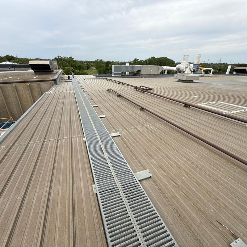 Metal roof with roof drain grate and ventilation units Metal roof with roof drain grate and ventilation units
