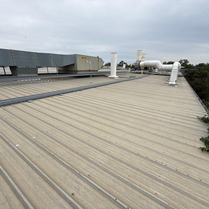 Metal roof with ventilation ducts and HVAC unit Metal roof with ventilation ducts and HVAC unit