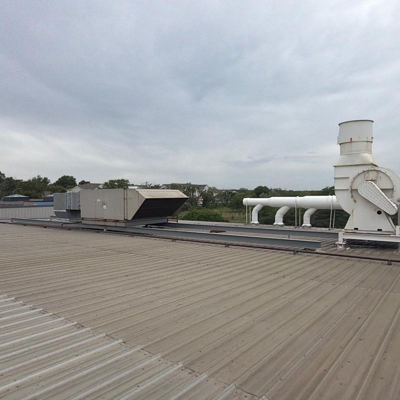 Commercial rooftop HVAC unit and vent pipes on metal roof Commercial rooftop HVAC unit and vent pipes on metal roof