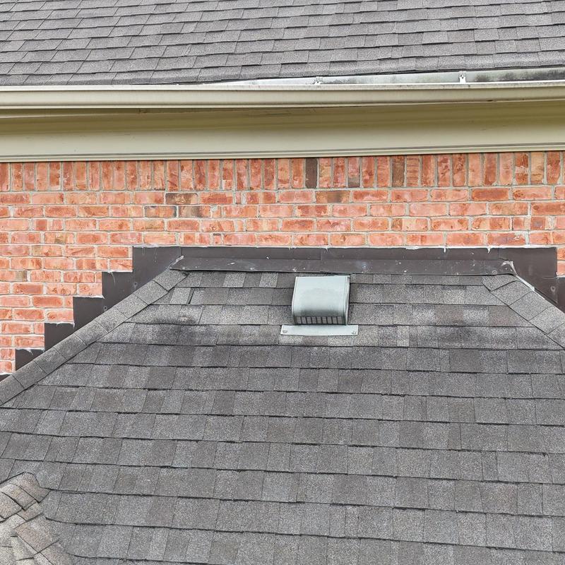 Roof shingles and vent with visible hail damage