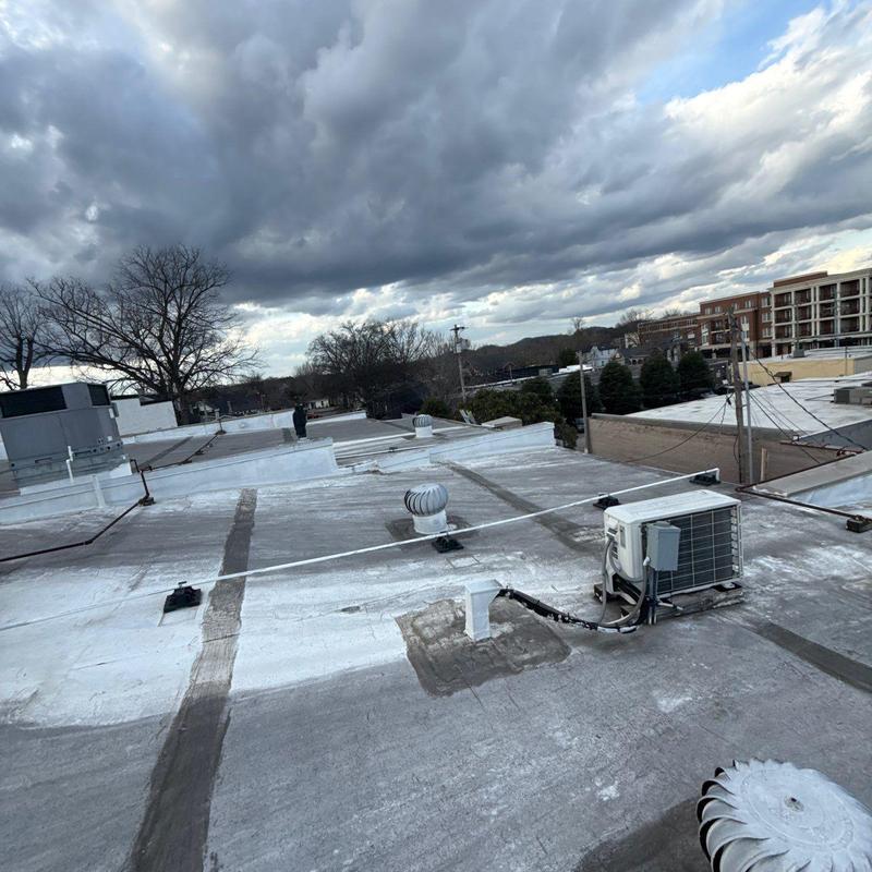 Commercial roof with HVAC units and flashing repairs