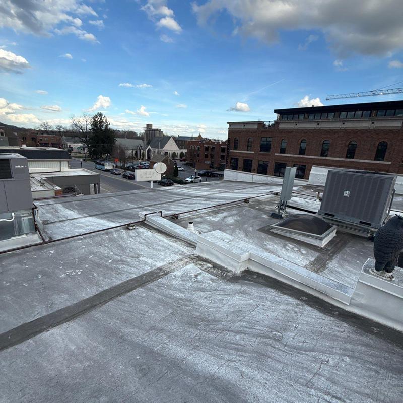 Commercial flat roof with hail damage and flashing defects