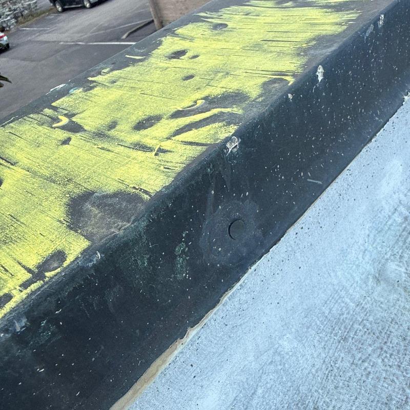 Roof flashing with hail damage and weathering marks