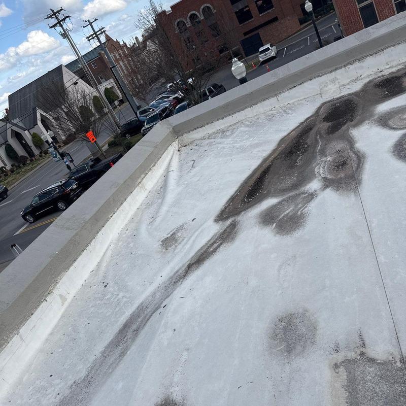 Commercial flat roof with hail damage stains