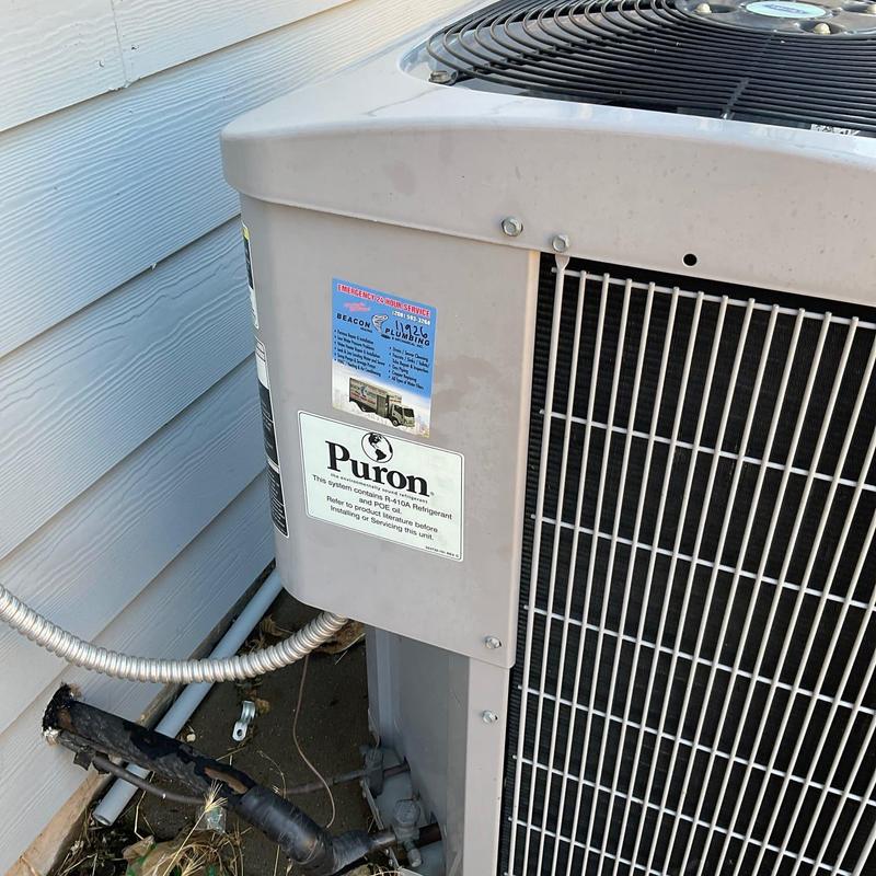 Outdoor air conditioner condenser unit frozen and serviced