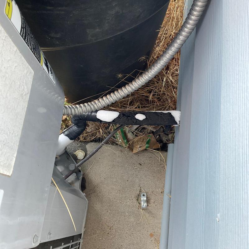 Frozen air conditioning unit pipes with frost buildup