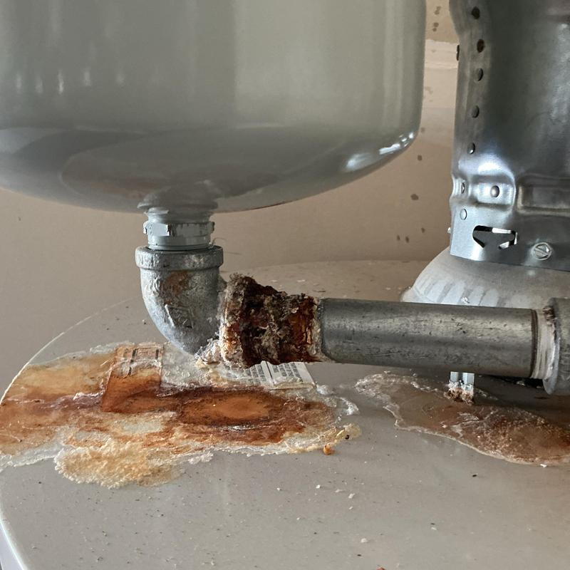 Water heater rusted pipe leak with corrosion damage Water heater rusted pipe leak with corrosion damage