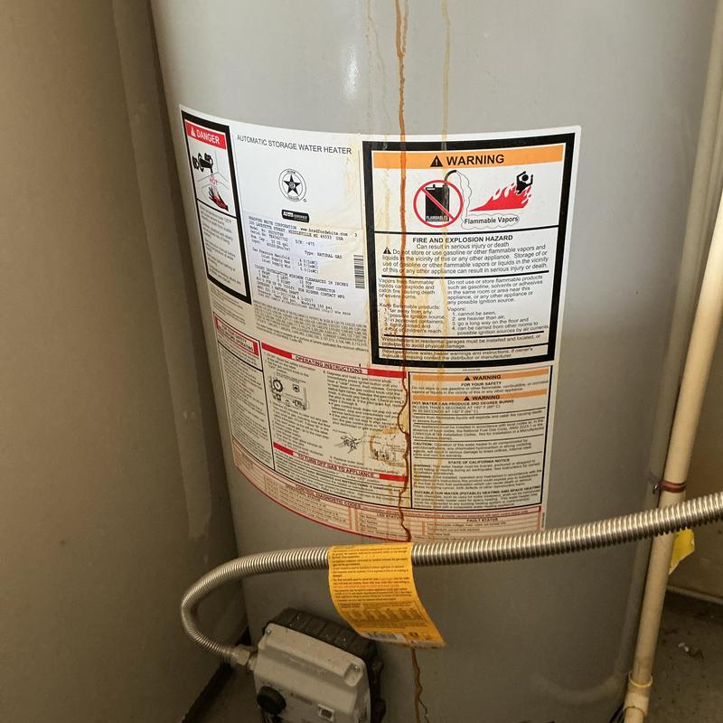 Water heater with rust streak and gas line connection Water heater with rust streak and gas line connection