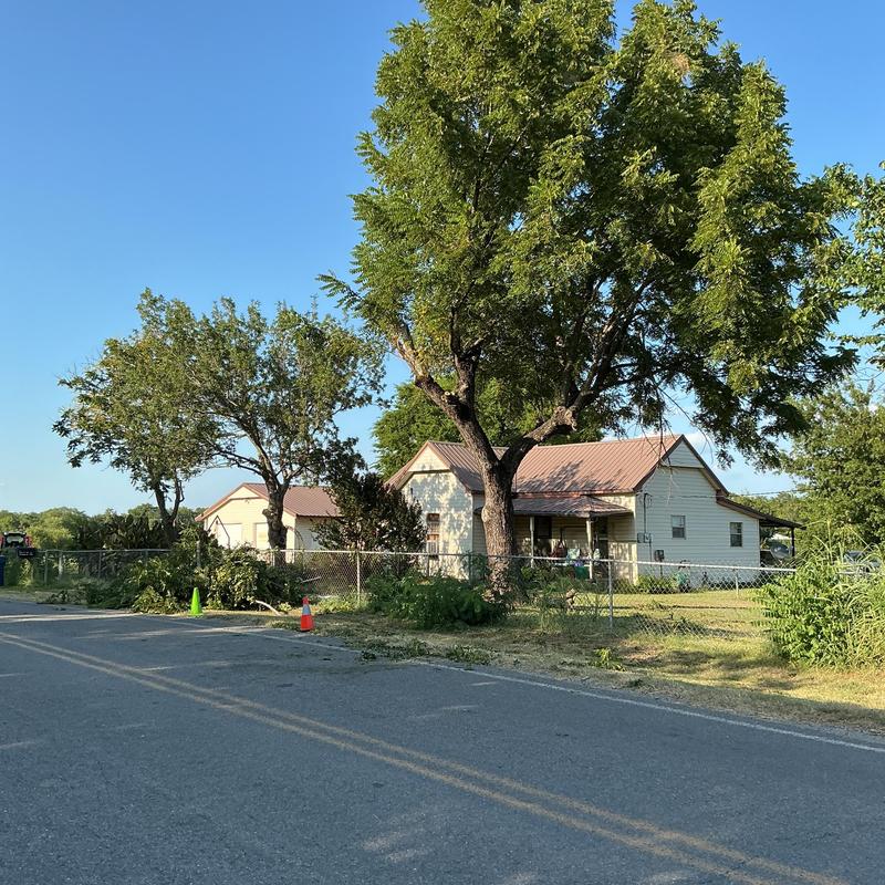 Tree limb removal near residential fence in Pittsburg County