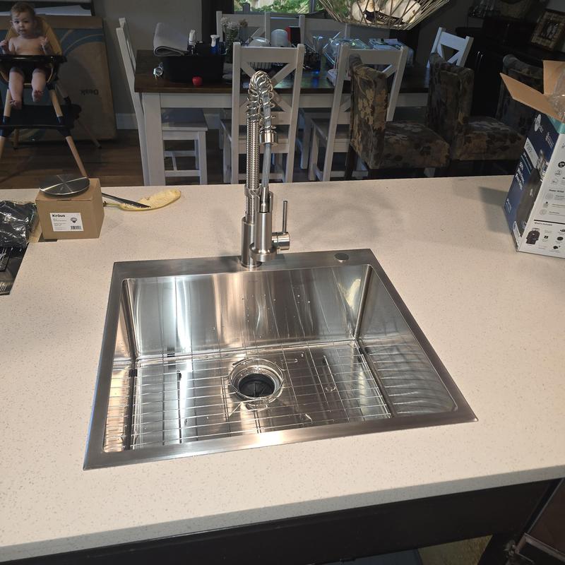 Kitchen sink with spring coil faucet installed on countertop