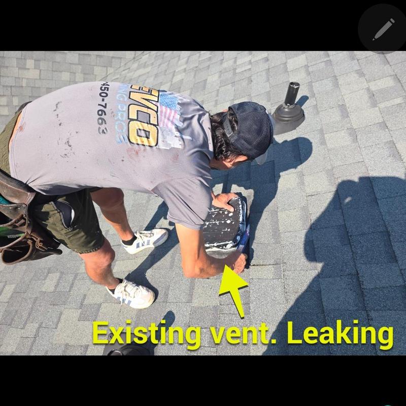 Bathroom vent on roof with leak being inspected