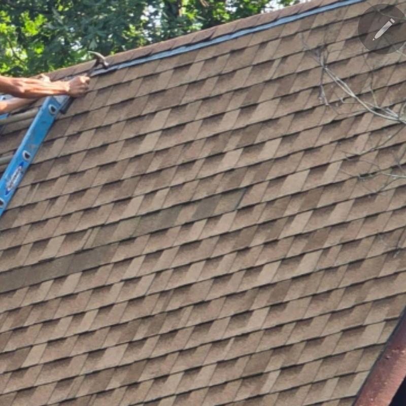 Asphalt shingles on A-Frame roof with ladder and hand