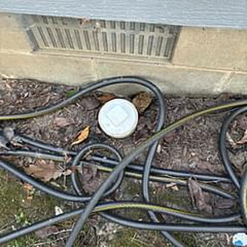Sewer line cleanout with inspection cap outdoors