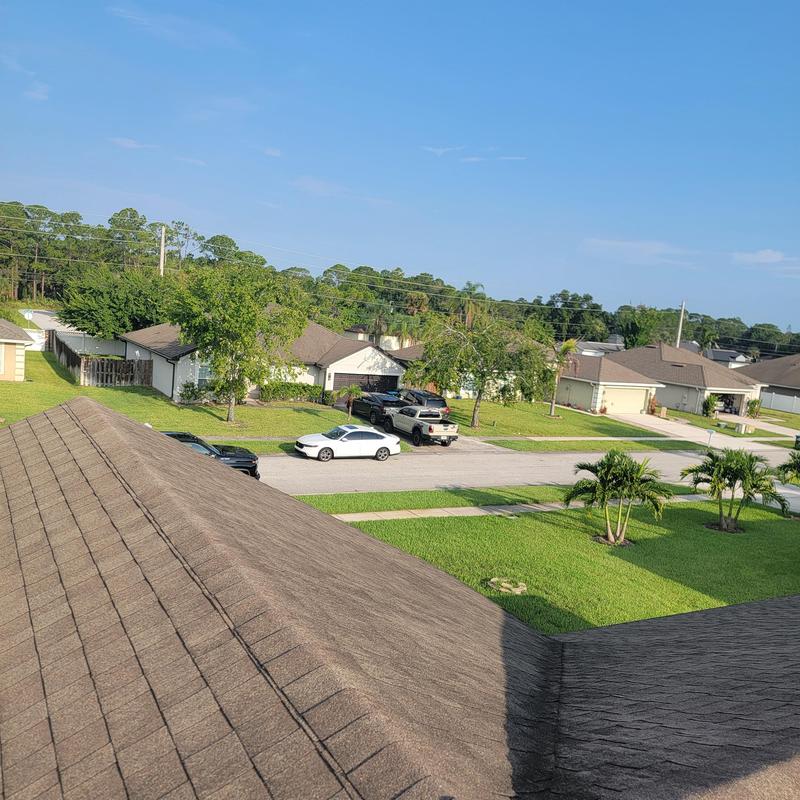 Shingle roof surface inspection from rooftop view Shingle roof surface inspection from rooftop view