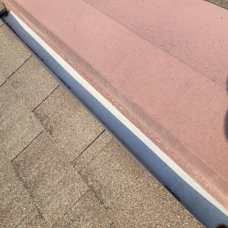 Roof valley and flashing inspection with exposed nails visible Roof valley and flashing inspection with exposed nails visible